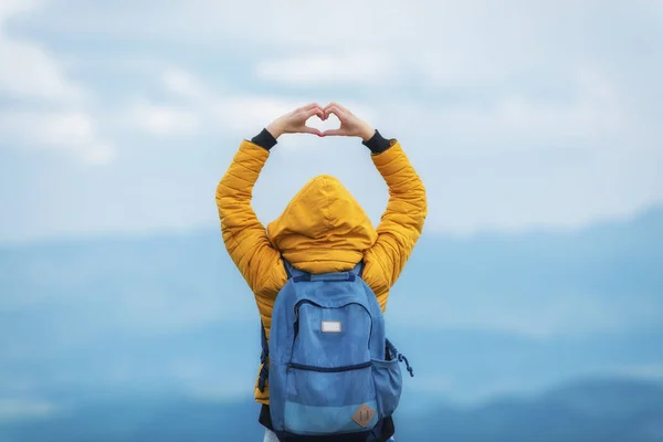 Girl holding a heart - shape in the nature.