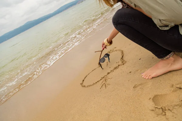 海の砂にハートを描く少女 海のビーチ — ストック写真