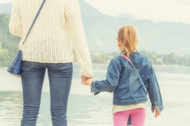 Anne ve kızı bir göl üzerinde manzarayı
