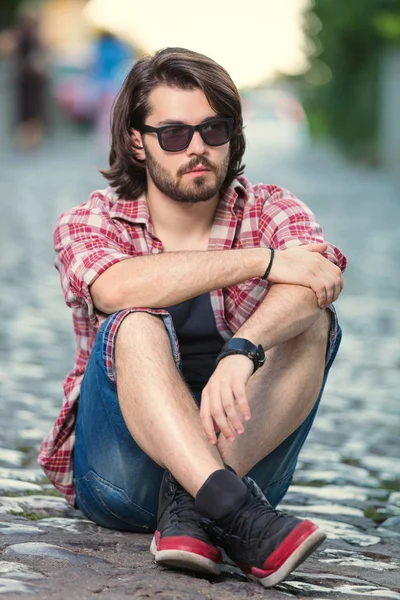 Young man posing in front of the camera.