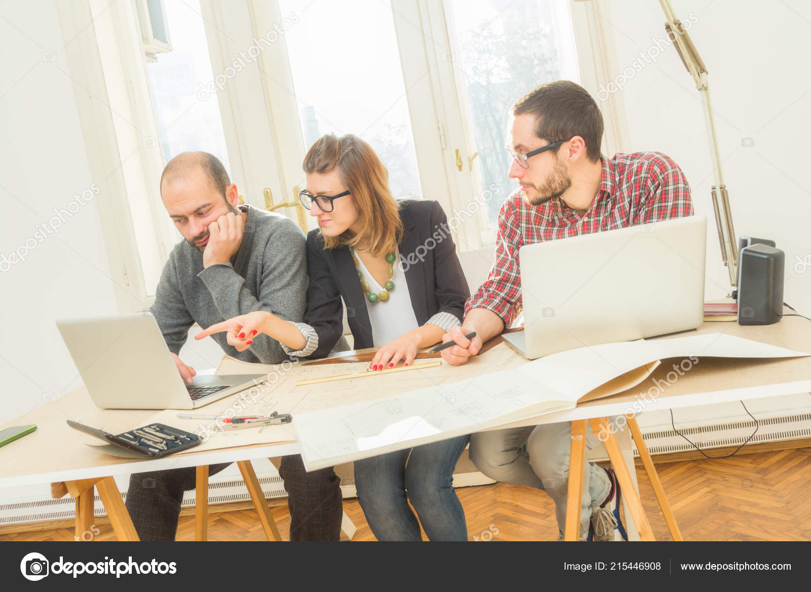Young Group People Discussing Business Plans Lap Tops Plans Room