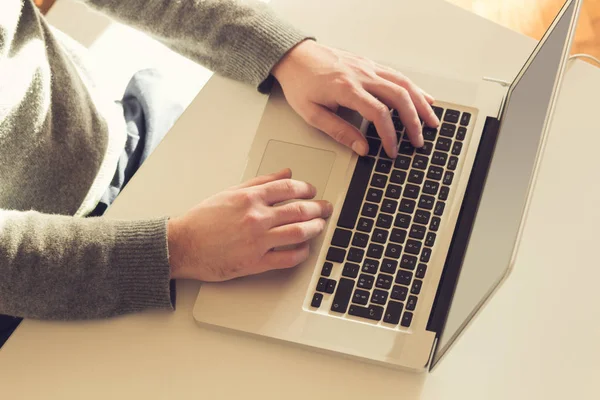 Male hands using keyboard of a lap-top.