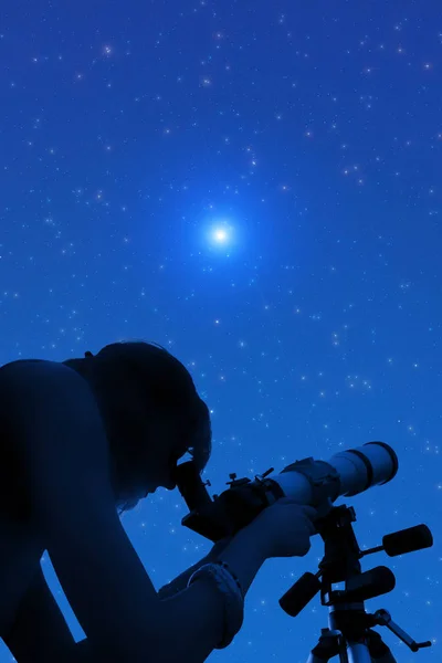 Silhouette of a girl while watching stars through the telescope.