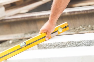 İnşaat işçisi zor tesviye beton kaldırım açık havada.