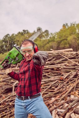 Testere ile kesme woods yığını ile oduncu.