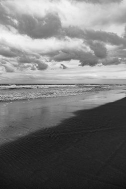 Black sand volcano beach on the ocean / sea coast.