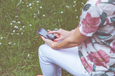 Parkta akıllı telefon kullanan kız.