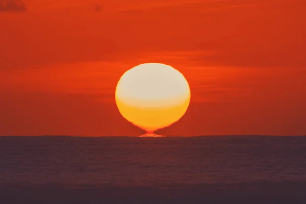 大きな望遠レンズで撮影した海の地平線から昇る朝日 — ストック写真