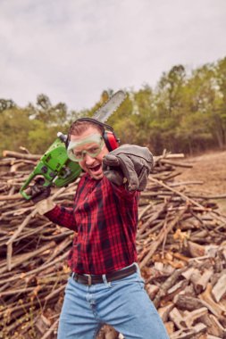 Testere ile kesme woods yığını ile oduncu.