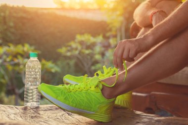 Man preparing for sports recreation on the home terrace.
