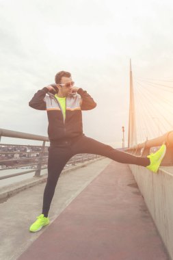 Kentsel jogger bir köprüde germe.