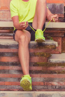 Man preparing for sports recreation on the home terrace.