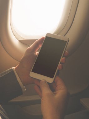 Uçağın içinde Smartphone kullanan adam.