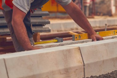 Beton bloklar tesviye teyp ölçme ile gerçek inşaat işçisi.
