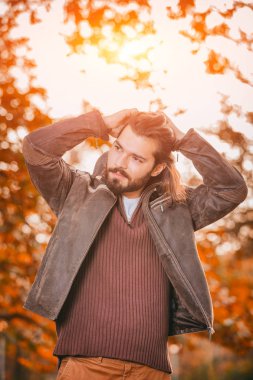 Yakışıklı genç adam giyen deri ceket Sonbahar sezonunda / soğuk hava.