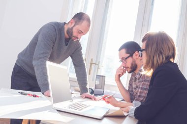 Güneşli bir ofiste Genç Mimarlar grubu.