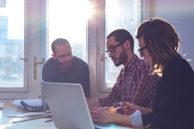 Güneşli bir ofiste Genç Mimarlar grubu.