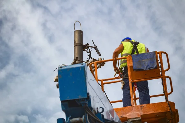 Power line worker fixing from the truck basket.