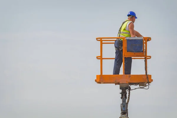 Power line worker fixing from the truck basket.