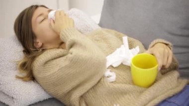 Doku tutarak ve mide ve çay tutan kız hasta.