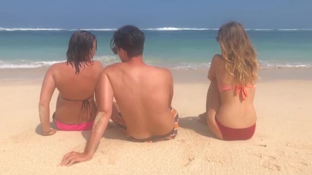 友人は 楽しんで時間熱帯の砂浜の上に座って — ストック動画