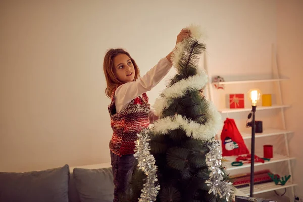 Child girl preparing shiny decoration for Christmas / New Year's — Stock Photo, Image