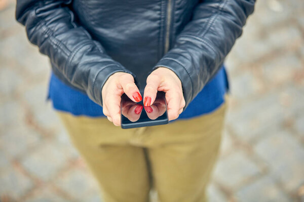 Женщина с современным смартфоном на улице.