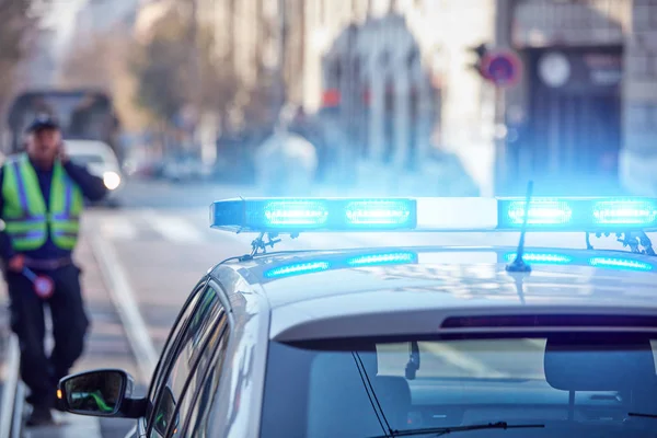 Coche de policía con luces azules en la escena del crimen en el tráfico / entorno urbano . — Foto de Stock