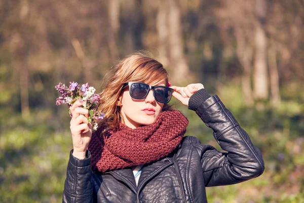 Симпатична молода дівчина пахне гарним букетом квітів у природі . — стокове фото