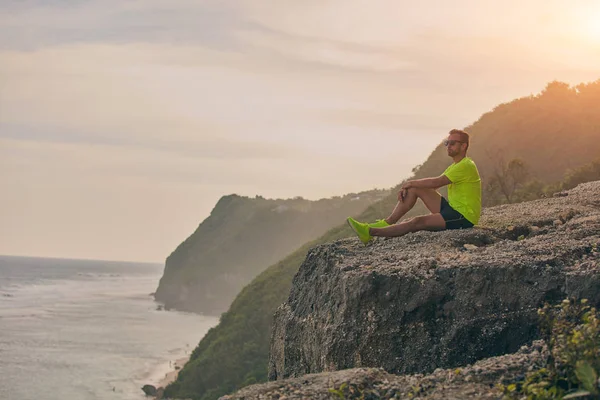 Deportista observando el paisaje tropical después del entrenamiento en una colina . — Foto de Stock
