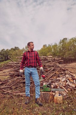 Testere ile kesme woods yığını ile oduncu.