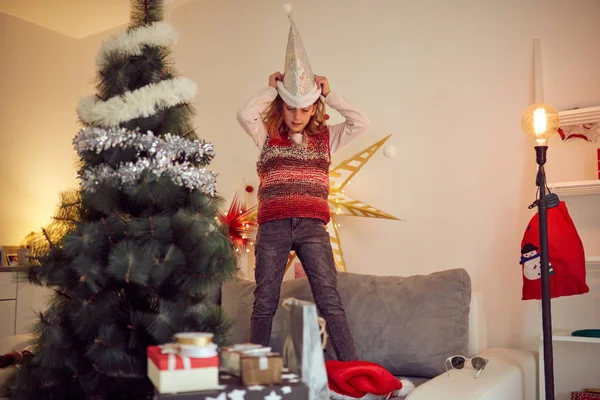 Child girl preparing shiny decoration for Christmas / New Year's — Stock Photo, Image