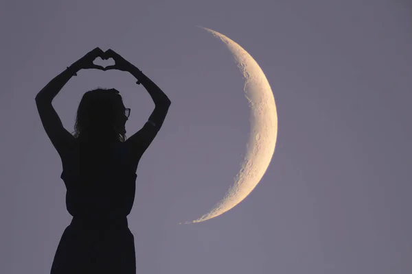 Girl holding a heart - shape with telescope, Moon and stars. My — Stock Photo, Image