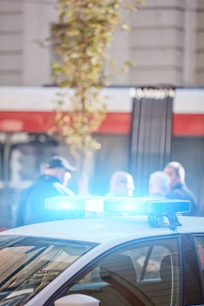 Voiture de police avec feux bleus sur la scène de crime dans la circulation / environnement urbain . — Photo