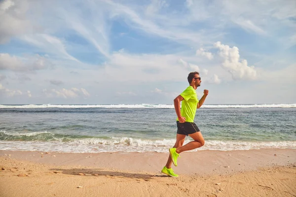 Uomo che corre / fa jogging su una spiaggia tropicale esotica . — Foto Stock