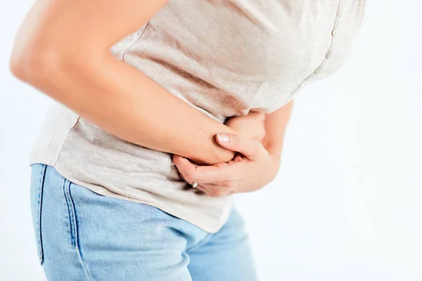 Vrouw met maag- / heupproblemen / problemen op de witte achtergrond — Stockfoto