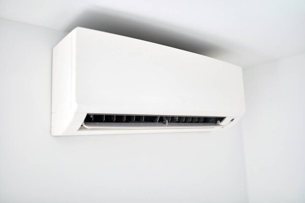 Moder air condition unit on a white wall inside the living room.