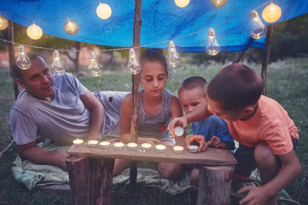 孩子们在后面搭一个有蜡烛和灯笼的小帐篷 — 图库照片