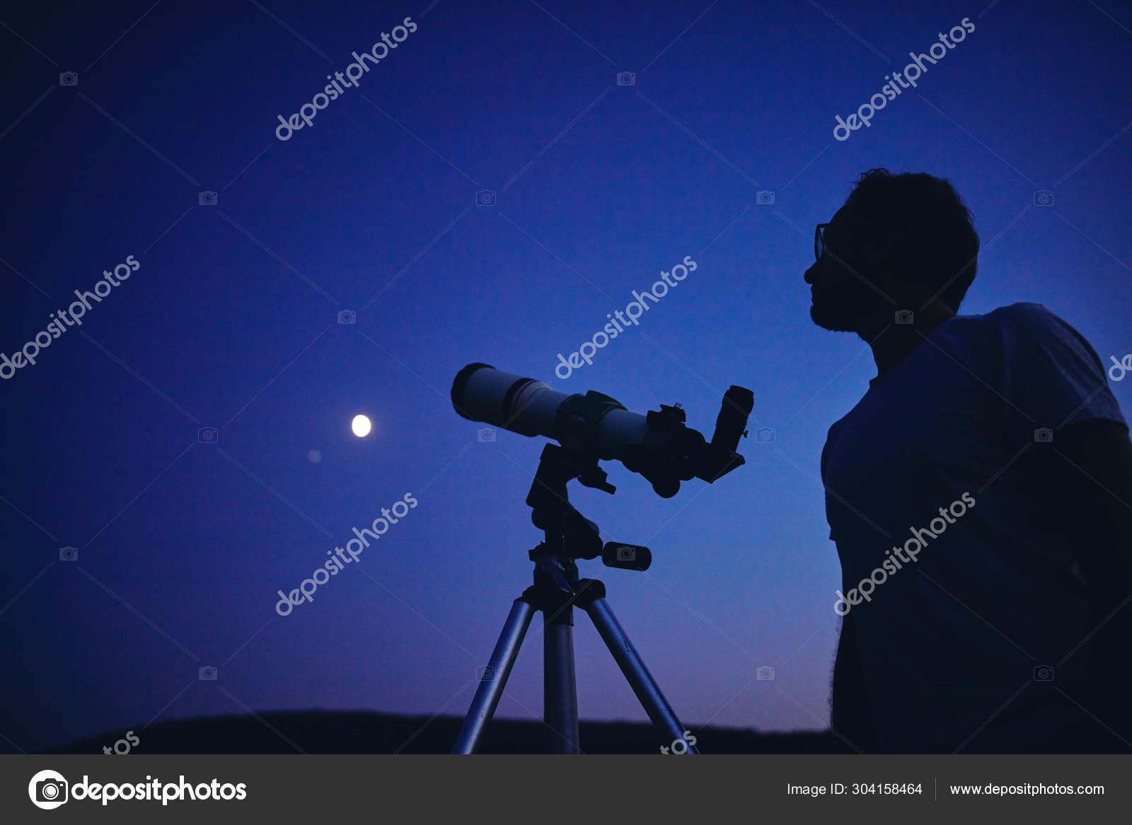 Astronomer with a telescope watching at the stars and Moon. My a Stock
