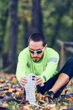 Adam parkta egzersiz yaptıktan sonra geriniyor..