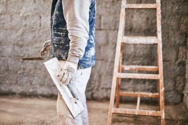 Gerçek inşaat işçisi yeni evin içinde bir duvar yapma.