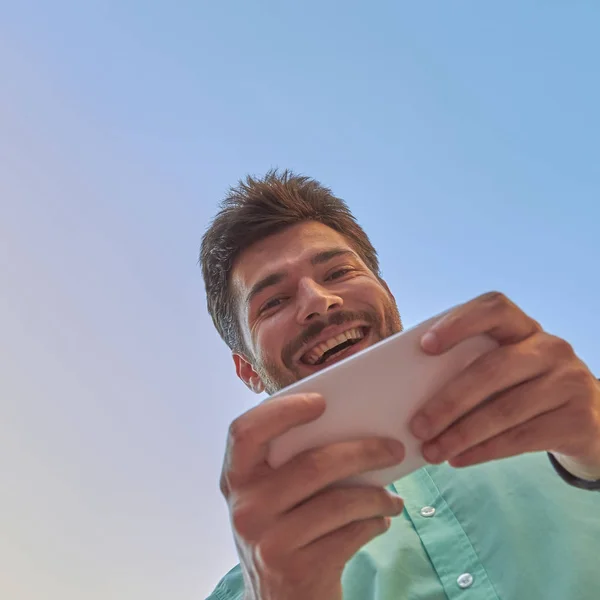 Good looking man using smartphone on the street.