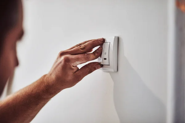 Electrician repairing / fixing wires in the wall.