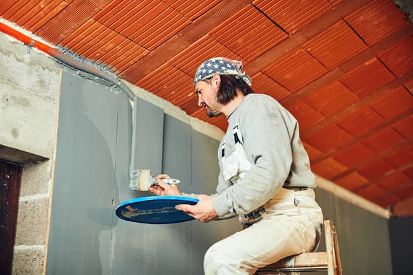 Painter painting walls with a paintbrush indoors. — Stock Photo, Image