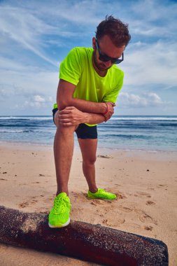 Tropikal kumlu plajda uzanan Sportsman.