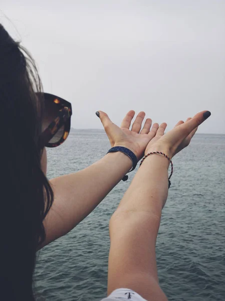 A tenger partján imádkozó karokkal rendelkező asszony. — Stock Fotó