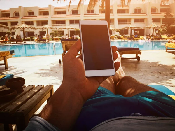 Άνθρωπος που χρησιμοποιεί κινητό κοντά στην πισίνα. — Φωτογραφία Αρχείου