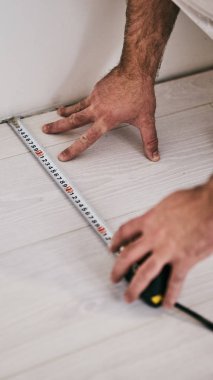 Ev Renovasyonu için bant ölçümü kullanan worksman.