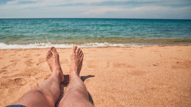 Yalan ve tropikal bir kumsalda zevk adam.