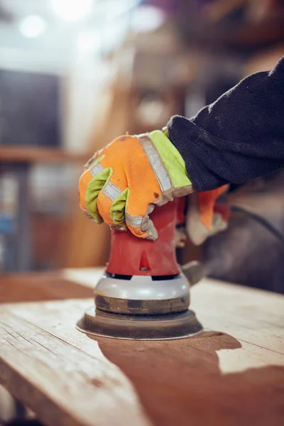 Carpenter using orbital electric sander in a retro vintage works — Stock Image Carpenter using orbital electric sander in a retro vintage works Royalty Free Stock Images